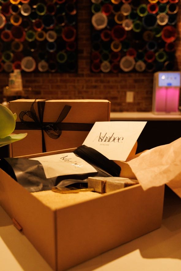 An opened box with tissue paper and the Ashabee card