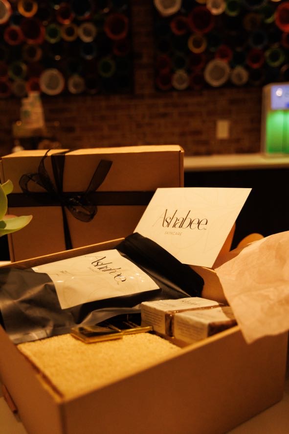An opened Ashabee box with a gold-foil card resting inside